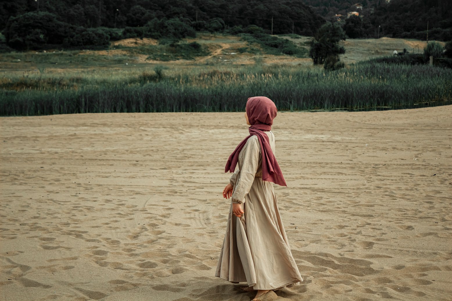 Woman Wearing Hijab Walking on the Sandy Shore